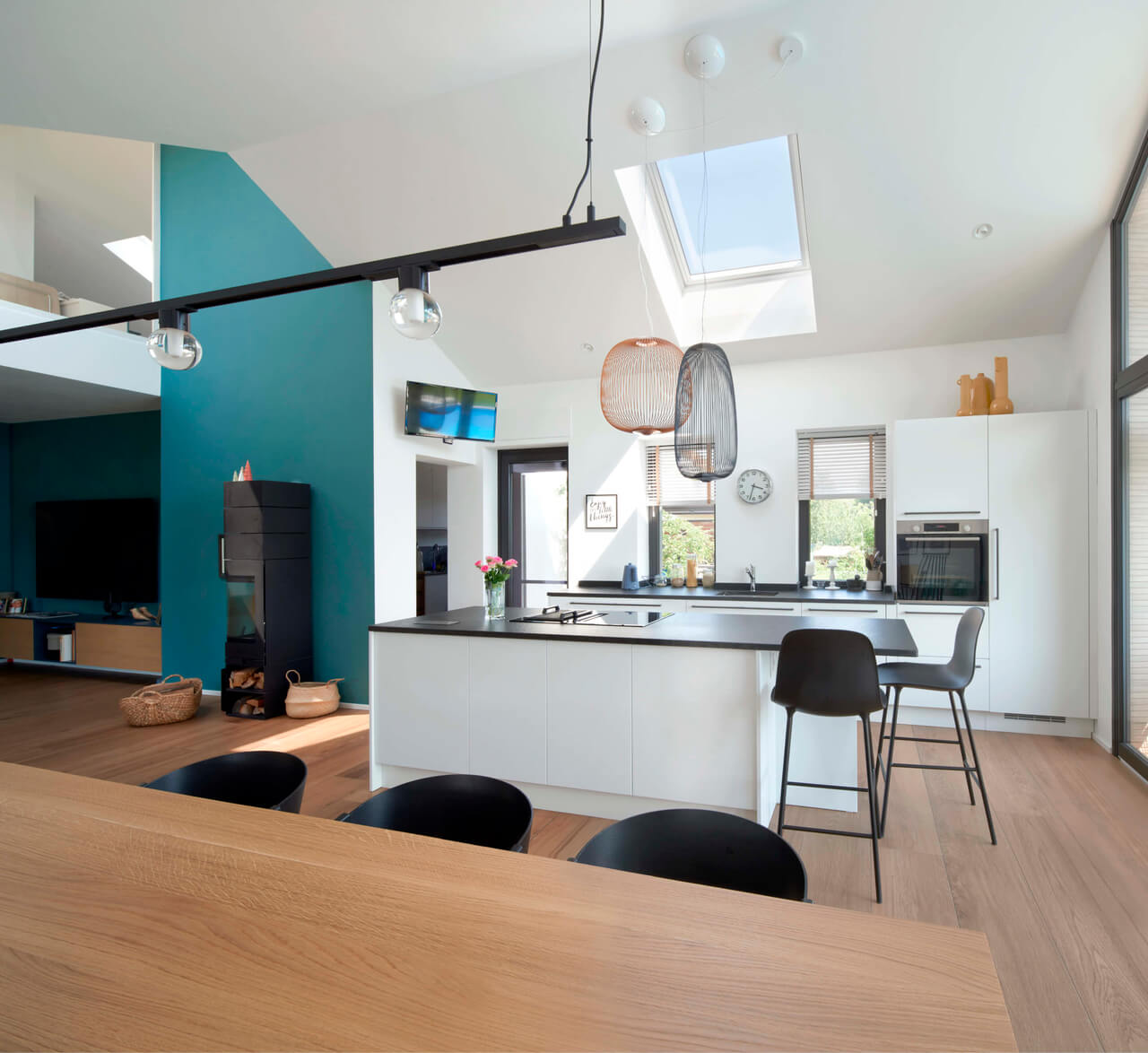 A bright kitchen and dining room area with a roof window