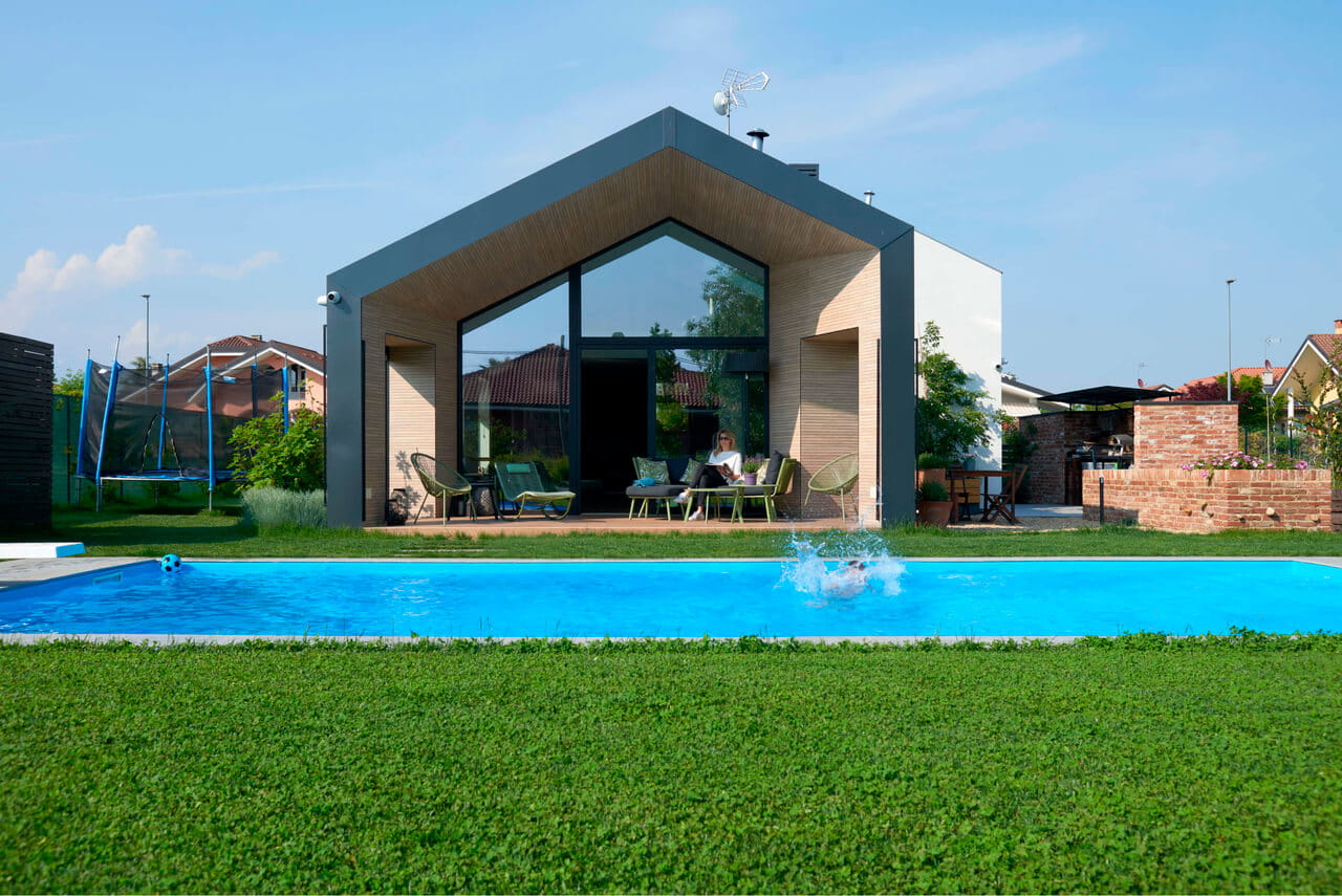 A modern house with a swimming pool in front yard