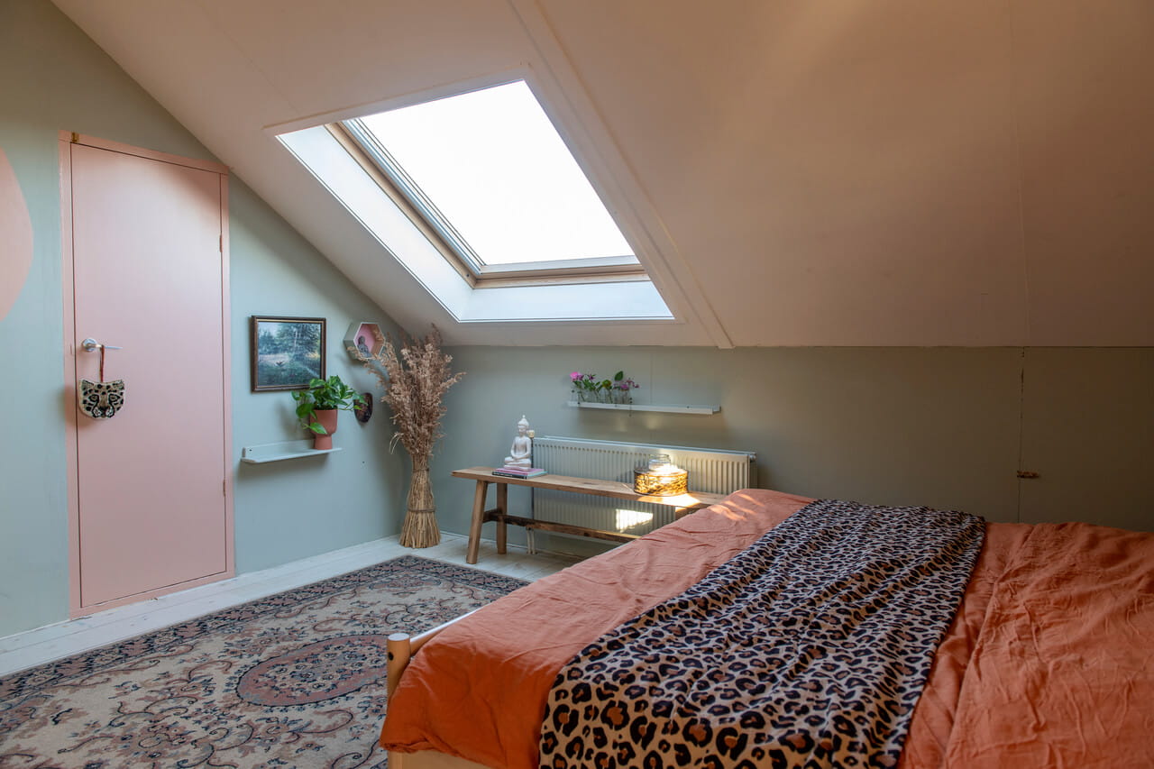 Bedroom in the attic with a roof window.