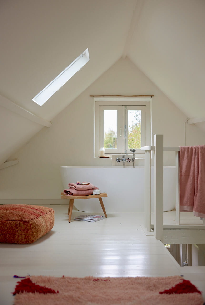 White painted attic with coral interior details.
