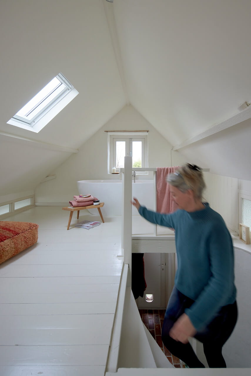Woman climbing up the stairs to the attic.