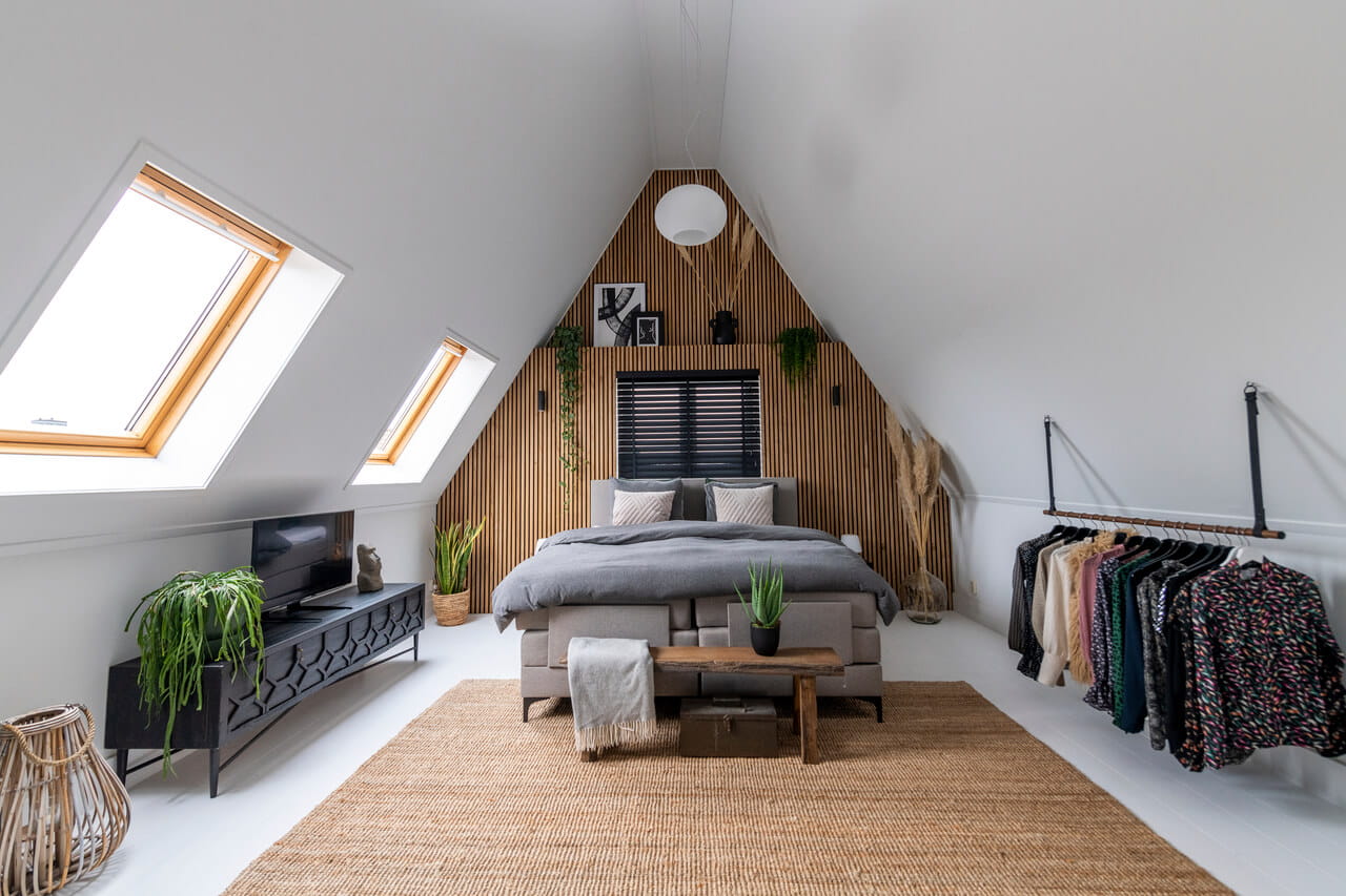 Bright bedroom in the attic with roof windows.