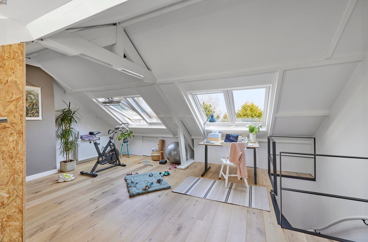 Home office and gym in the attic with roof windows.